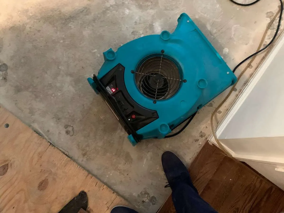 Air mover drying subfloor during Commercial Water Damage Restoration in Dryden